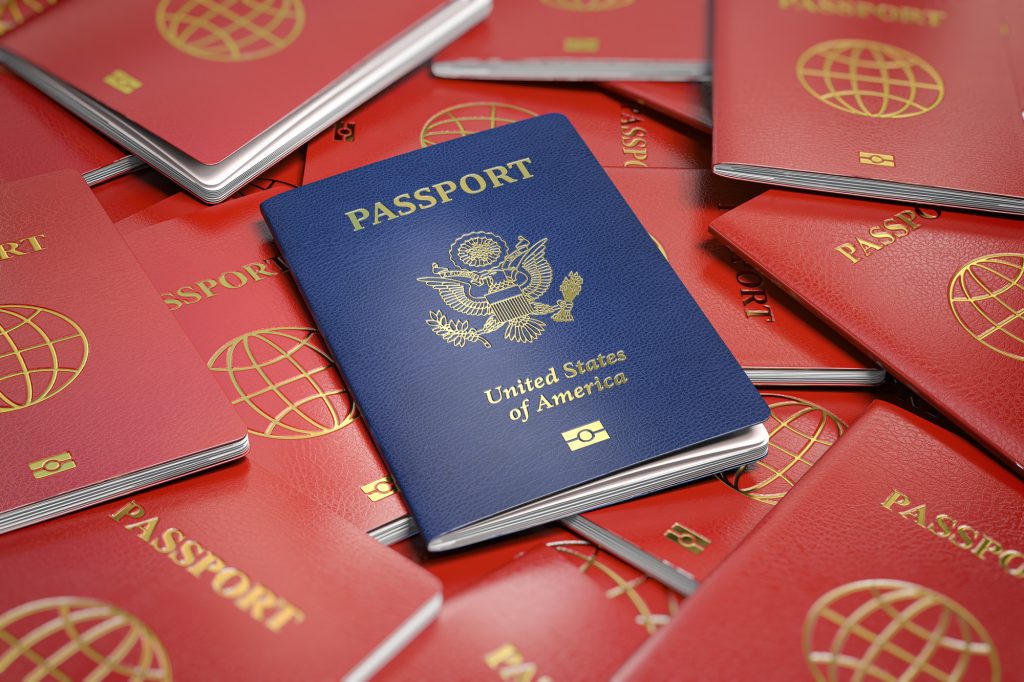 Passport of USA on the pile of passports of other countries. Immigration concept.